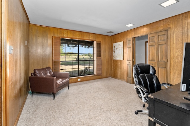 office featuring light colored carpet and wooden walls