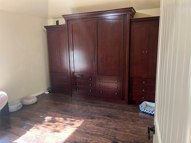 unfurnished bedroom with dark wood-type flooring