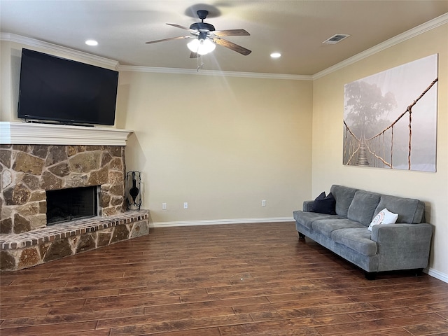 living room with ceiling fan, ornamental molding, dark hardwood / wood-style flooring, and a fireplace