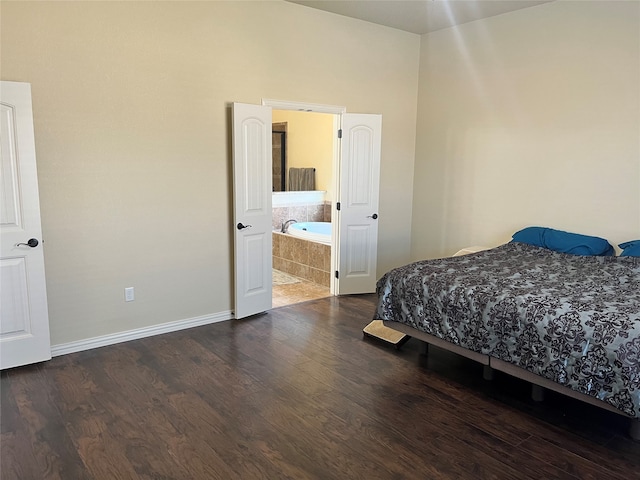 bedroom featuring hardwood / wood-style flooring and ensuite bath