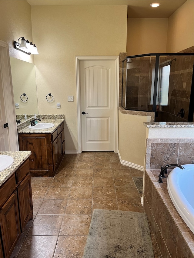 bathroom featuring vanity and shower with separate bathtub