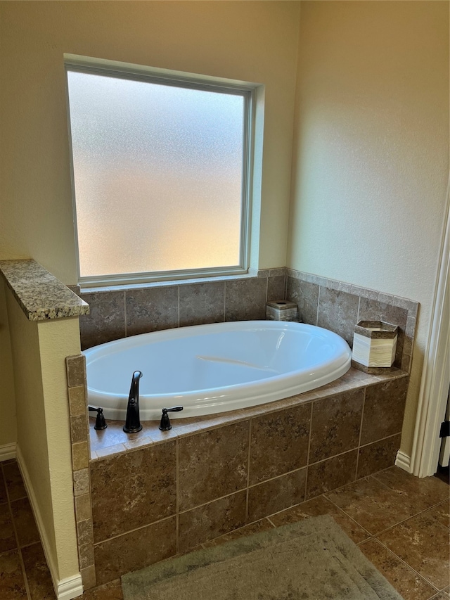 bathroom featuring tiled tub