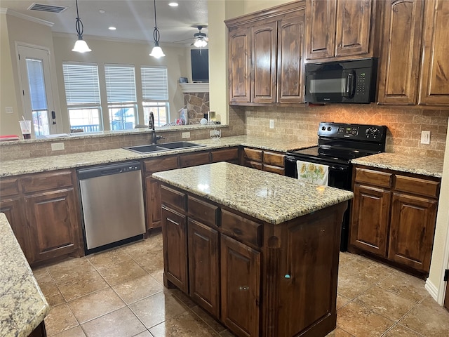 kitchen featuring black appliances, sink, pendant lighting, and decorative backsplash