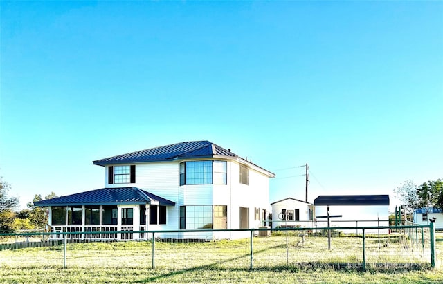 exterior space featuring covered porch and a yard