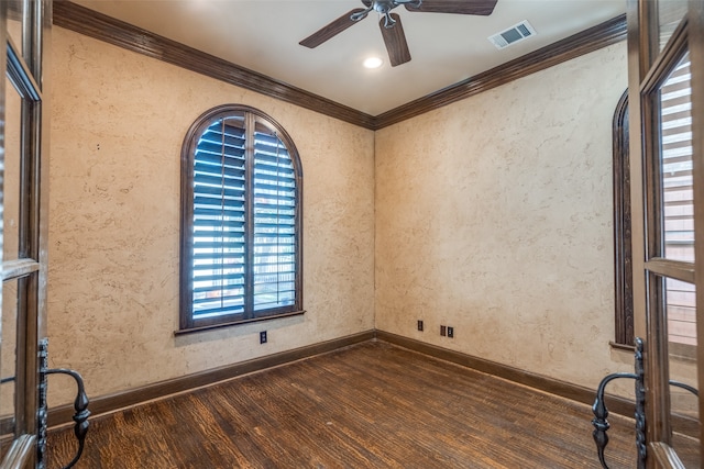 unfurnished room with crown molding, dark hardwood / wood-style floors, and a wealth of natural light