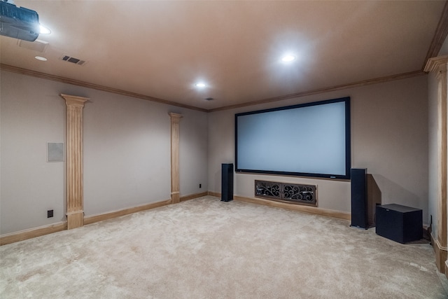 carpeted cinema room with ornate columns and crown molding