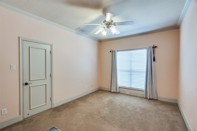 unfurnished room featuring crown molding, light colored carpet, and ceiling fan