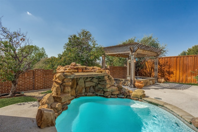 view of swimming pool with a patio area, pool water feature, and a pergola