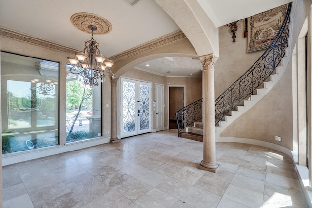 6809 Beckworth Ln, Plano, TX 75024 - foyer entrance featuring ornamental molding, stone tile floors, stairs, a chandelier, and arched walkways
