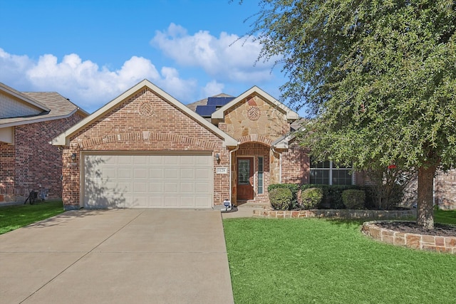 view of front of house with a garage and a front lawn