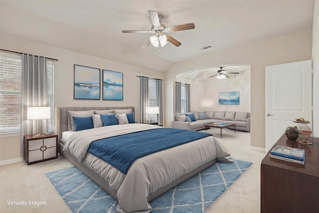 carpeted bedroom with ceiling fan and vaulted ceiling