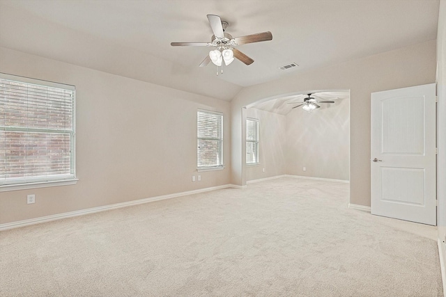 carpeted spare room with ceiling fan and lofted ceiling