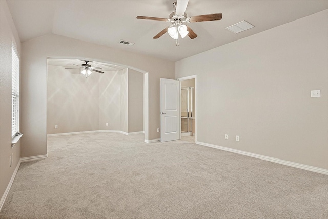 carpeted empty room with vaulted ceiling and ceiling fan