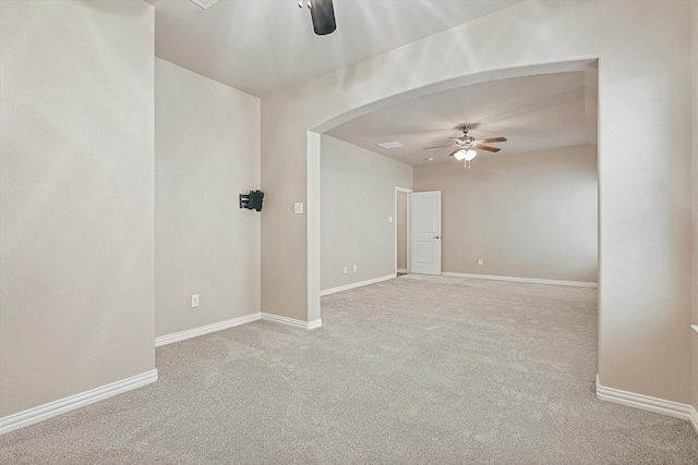 carpeted spare room featuring ceiling fan