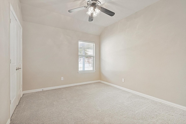 spare room with carpet flooring, ceiling fan, and vaulted ceiling