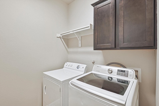 laundry room with cabinets and separate washer and dryer