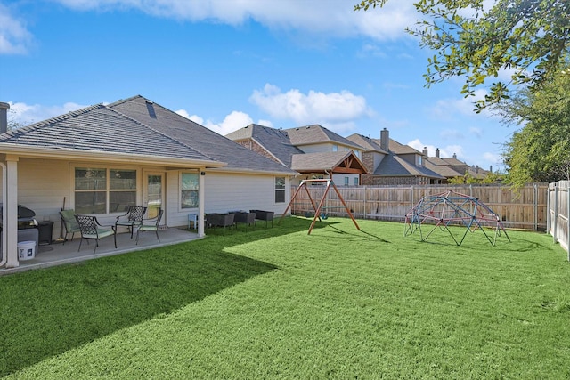 view of yard with a playground and a patio area