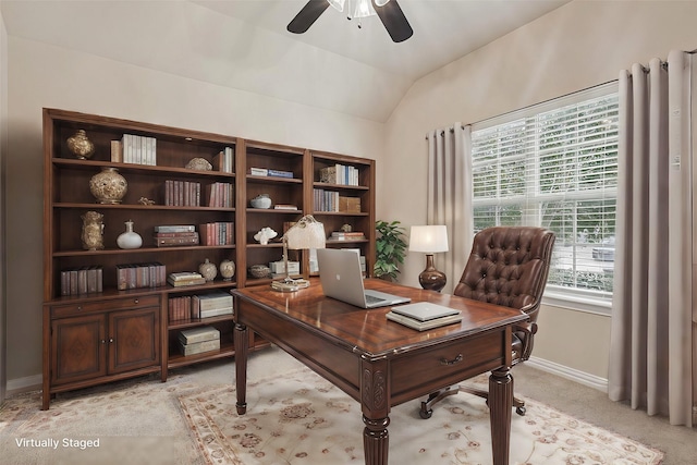 office featuring light carpet, vaulted ceiling, and ceiling fan