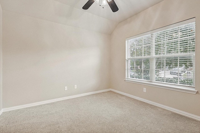 carpeted empty room with ceiling fan and lofted ceiling