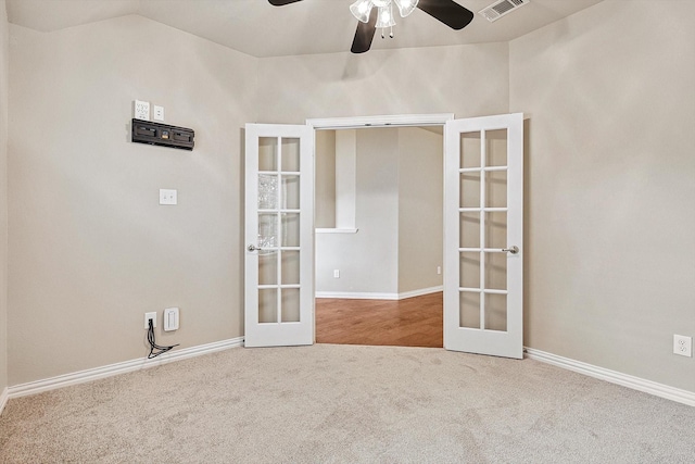 carpeted empty room with french doors, ceiling fan, and lofted ceiling