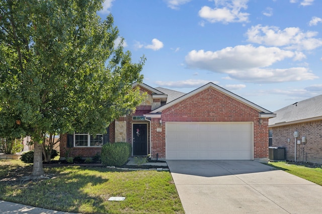 view of front of property with a garage, a front lawn, and central AC unit