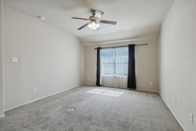 spare room featuring ceiling fan, light carpet, and lofted ceiling