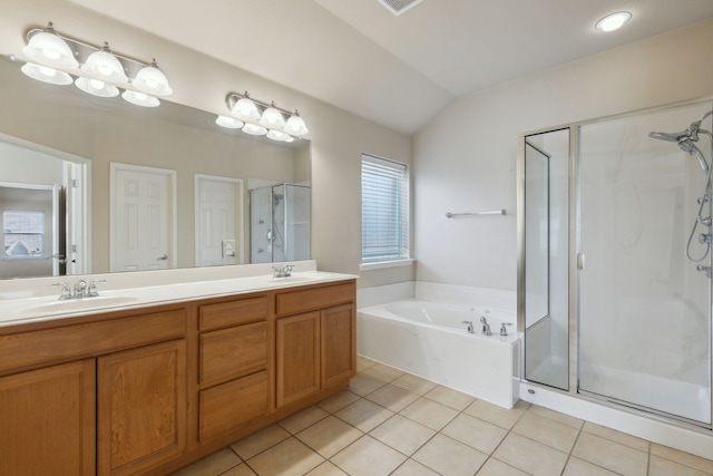 bathroom featuring vanity, shower with separate bathtub, vaulted ceiling, and tile patterned floors