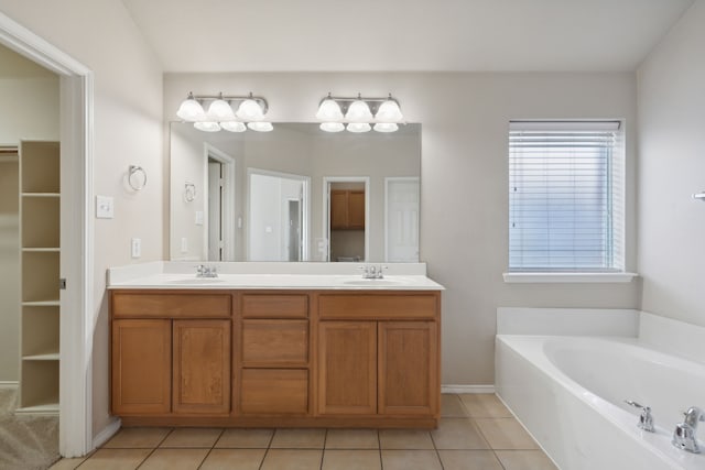 bathroom featuring vanity, tile patterned flooring, and a washtub