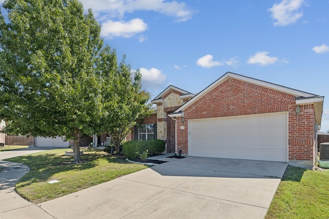 view of front of home with a garage and a front lawn