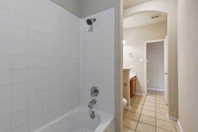 full bathroom with vanity, toilet, tile patterned floors, and tiled shower / bath combo