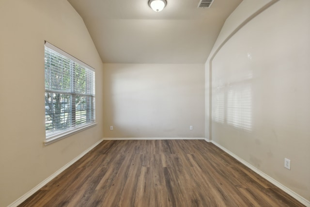 spare room with lofted ceiling and dark hardwood / wood-style floors