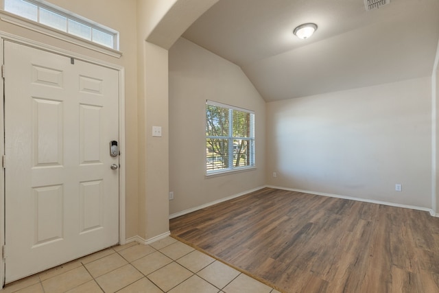 entryway featuring lofted ceiling and light hardwood / wood-style floors