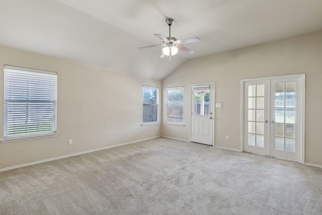 carpeted empty room with lofted ceiling, french doors, plenty of natural light, and ceiling fan