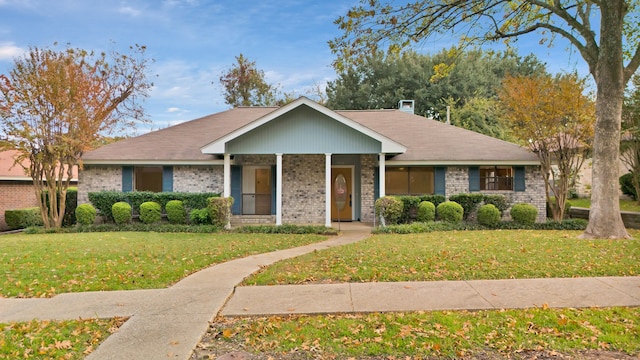 view of front of property with covered porch and a front lawn