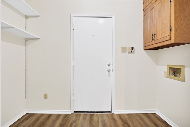 clothes washing area featuring cabinets, washer hookup, and dark hardwood / wood-style flooring