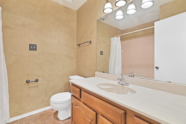 bathroom featuring vanity, tile patterned floors, and toilet