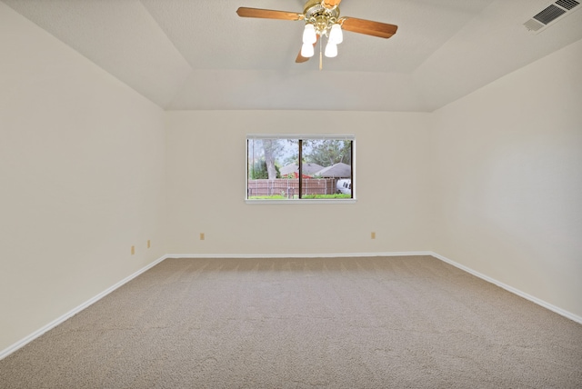 empty room featuring carpet floors, ceiling fan, and a tray ceiling