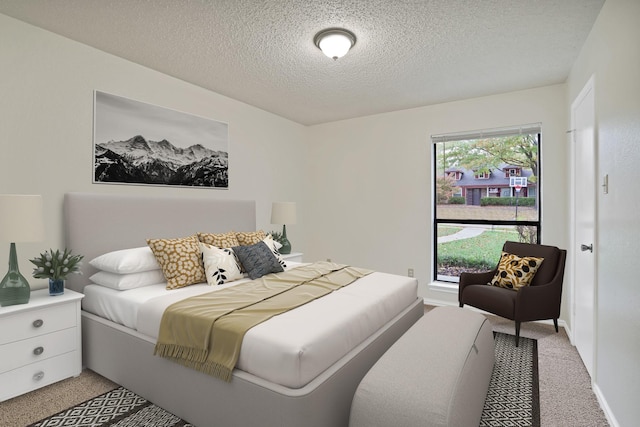 carpeted bedroom featuring multiple windows and a textured ceiling