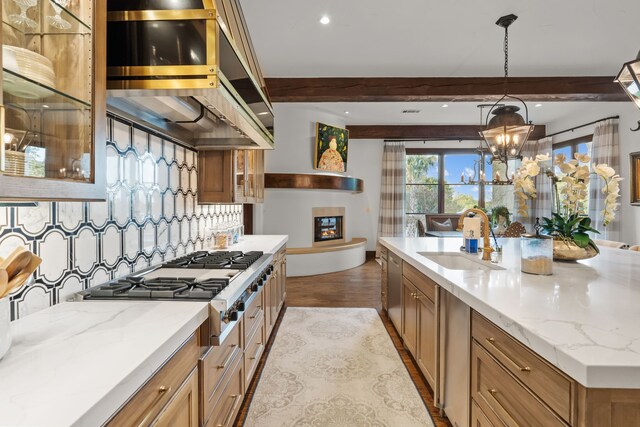 kitchen with beam ceiling, a spacious island, premium range hood, and stainless steel appliances