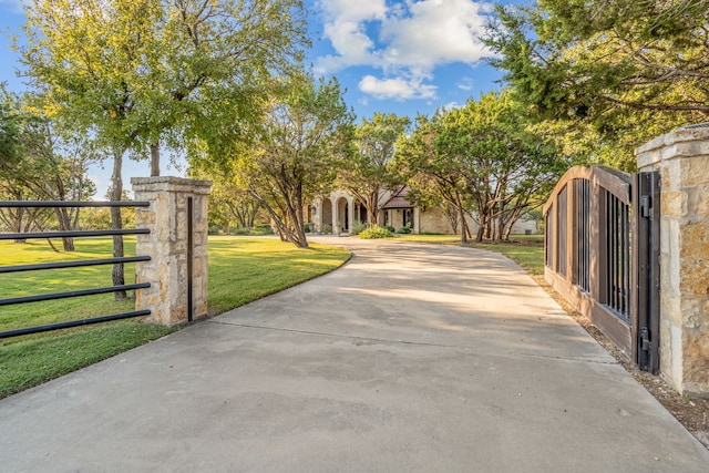 view of gate featuring a yard