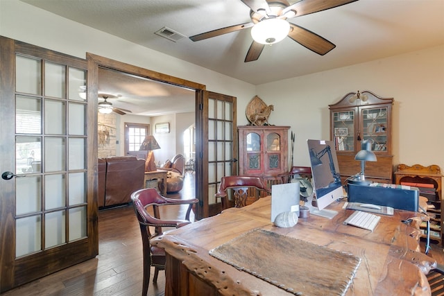 dining space featuring french doors, a textured ceiling, and dark hardwood / wood-style flooring