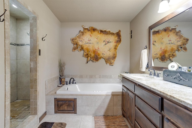 bathroom with vanity, tile patterned floors, and plus walk in shower