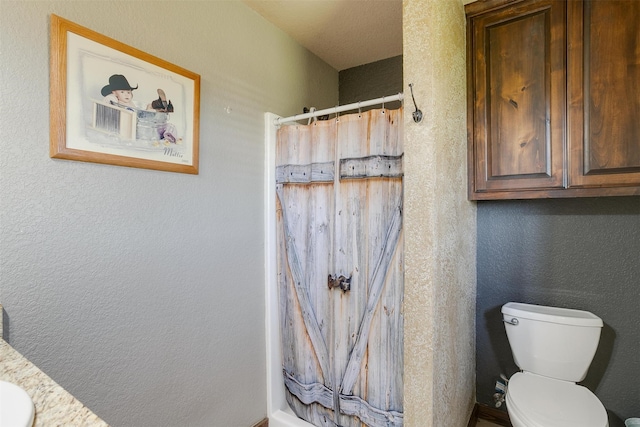 bathroom with walk in shower and toilet