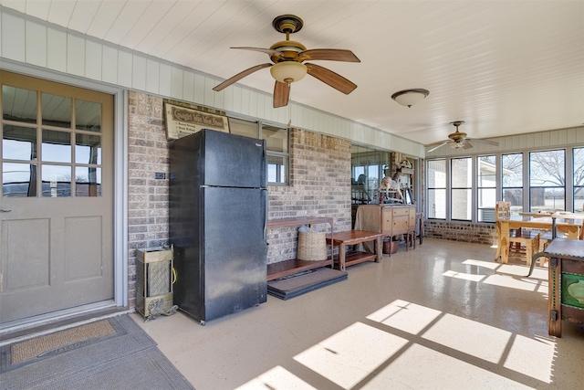 sunroom / solarium featuring ceiling fan