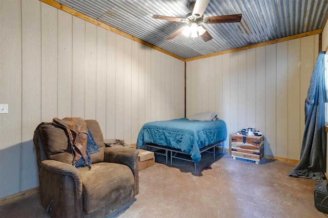 bedroom featuring concrete flooring, wooden walls, and ceiling fan