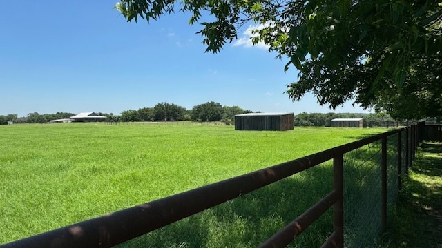 view of yard with a rural view