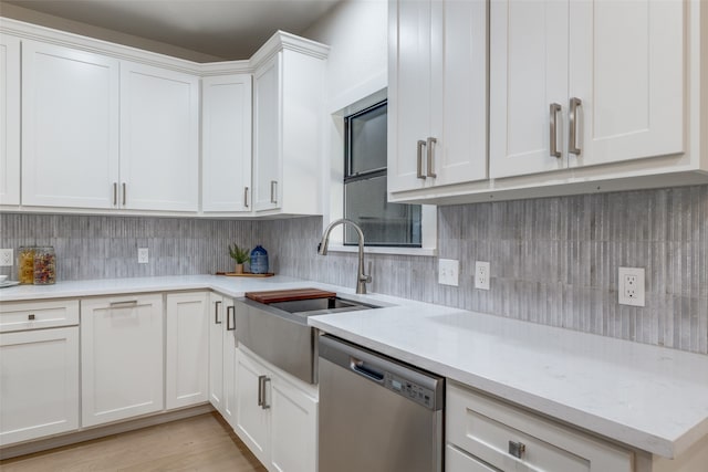 kitchen with light stone countertops, sink, dishwasher, light wood-type flooring, and white cabinets