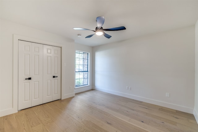 unfurnished bedroom featuring light hardwood / wood-style floors, a closet, and ceiling fan