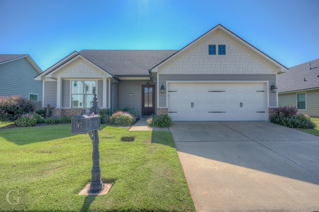 view of front facade featuring a garage and a front lawn