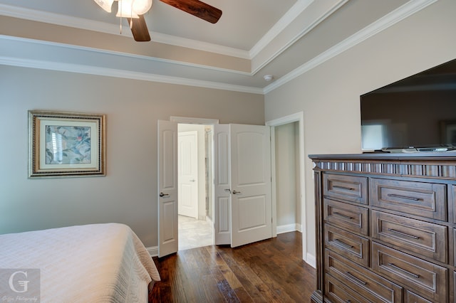 bedroom featuring crown molding, dark wood-type flooring, and ceiling fan